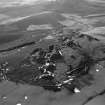 Oblique aerial view centred on the remains of quarries, taken from the NE.