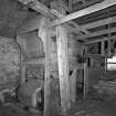 Detail of threshing machine in barn.