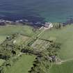 Oblique aerial view of Dunbeath Castle and walled gardens from SW.