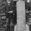 Scanned image of a photograph of John Nicolson standing beside an example of his sculpture.