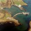 Oblique aerial view centred on the construction of the new pier, with harbour, pier and fish traps adjacent, taken from the S.