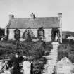 View of people at Sgreadan Cottage, Colonsay.