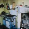 Scanned image of colour slide.
Mingulay, view of house interior - kitchen with fireplace and cooker.