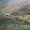 Scanned image of colour slide.
Aerial view of roundhouses, settlement mound, field banks and cultivation remains, from SE.