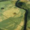 Oblique aerial view centred on the remains of the square barrow with the cropmarks of rig, pit-alignments and barrows adjacent, taken from the SSW.