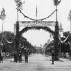Historic photograph.
General view of The Square which has been dressed up with foliage and banners to celebrate the home coming of the laird.  One reads 'Welcome to the Laird of Grant To the Land of his Fathers'.
