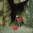RCAHMS AT WORK. Cave entrance being surveyed by James Hepher, Survey and Graphics, using EDM.