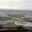 Scanned image of oblique aerial view, from SE, centred on the island of Burray and Churchill Barrier No. 4, and showing Burray village in the left centre of the photograph.