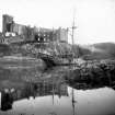 General view of Dunvegan Castle from west with sailing ship at anchor.
