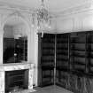 Interior.
View of apartment with chimneypiece, overmantel mirror and bookcases.
