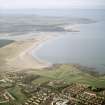 General oblique aerial view looking across the school, club house and Belhaven Bay towards North Berwick Law, the Firth of Forth and the Bass Rock, taken from the ESE.