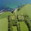 Oblique aerial view of Dunbeath Castle and walled gardens from NW.