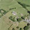 Oblique aerial view centred on Whithorn church, burial ground and remains of the priory, taken from the SSW.
