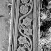 Skye, Eynort, St. Maelrubha's Church, Cross shaft.
Detail of back of cross shaft, with lion and curling foliage and flowers.