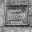 Entrance, carved panel containing monogram dated 1869, detail