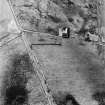 Oblique aerial view centred on Achingills farmsteading, taken from the NNE.