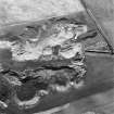 Oblique aerial view centred on the remains of Hill of Forss quarry and windmill, taken from the S.