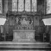 Copy of photograph showing altar and reredos showing Last Supper, Agnus Dei (Lamb of God) and angels supporting shield (coat of arms).
