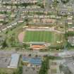 Oblique aerial view centred on Cliftonhill football stadium, Coatbridge, taken from the SSW.