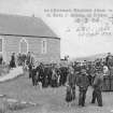 Postcard view of people gathering outside the church.