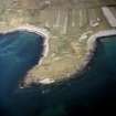 Oblique aerial view centred on Ardmichael burial grounds and site of the possible chapel, South Uist, taken from the W.