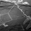 Oblique aerial view centred on the remains of a settlement, ring ditches and field system at Burn of Mannie, looking to to the ESE.