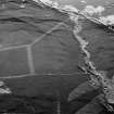 Oblique aerial view centred on the remains of a settlement, ring ditches and field system at Burn of Mannie, looking to to the ESE.