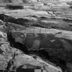 Oblique aerial view centred on the remains of a hut circle, field system, farmstead and rig at Redcastle and Blackhills, looking to the SW.