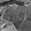Oblique aerial view centred on the cropmarks of the timber hall, ring ditch, enclosures and pits at Mondobbo House, looking to the ESE.
