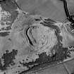 Scanned image of oblique aerial view centred on the remains of the fort and settlement with rig adjacent, taken from the W.