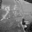 Oblique aerial view centred on the cropmarks of the enclosure, rig, pits and possible rectangular buildings at Legatesden, looking to the WNW.