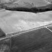 Oblique aerial view centred on the cropmarks of the circular enclosure at Barflat, looking to the SE.