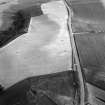 Oblique aerial view centred on the cropmarks of the circular enclosure at Barflat, looking to the SSW.