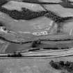 Oblique aerial view centred on cropmarks of the unenclosed settlement, roundhouses and rig at Logie House, looking to the NNE.
