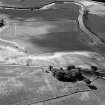 Oblique aerial view centred on the cropmarks of an enclosure, ring ditches, field system and pits at Wester Fintray, looking to the SSW. 

