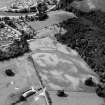 Oblique aerial view centred on the cropmarks of the palisaded enclosure, linear features, pits and rig at Heogan and East Mains of Aboyne, looking to the SSW.

