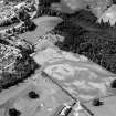 Oblique aerial view centred on the cropmarks of the palisaded enclosure, linear features, pits and rig at Heogan and East Mains of Aboyne, looking to the SSW.

