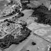 Oblique aerial view centred on the cropmarks of the palisaded enclosure, linear features, pits and rig at Heogan and East Mains of Aboyne, looking to the SW.

