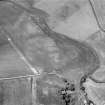 Oblique aerial view centred on the cropmarks of the unenclosed settlement, ring ditches and pits at Newmill with the mill house adjacent, looking to the WSW.