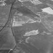 Oblique aerial view centred on the cropmarks of the unenclosed settlement, ring ditches, pits and rig at Bloodymire, looking to the WNW.