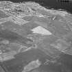 General oblique aerial view west of the cropmarks of the unenclosed settlement, ring ditches, pits and rig at Bloodymire, looking to the NW.