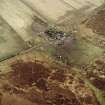 Oblique aerial view centred on the farmsteading, taken from the W