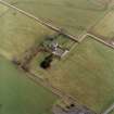 Oblique aerial view centred on the farmsteading and manse, taken from the NW