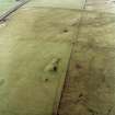 Oblique aerial view centred on the remains of the cairns, taken from the SE.