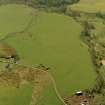 Oblique aerial view centred on the remains of the rig, small cairns, hut-circles and quarry, taken from the ESE.