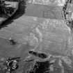 Oblique aerial view centred on the cropmarks of the possible field boundary, looking to the ENE.
