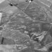 Oblique aerial view centred on the cropmarks of the unenclosed settlement at Wester Sinnahard, looking to the SE.