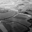 General oblique aerial view centred on the cropmarks of a palisaded enclosure, ring ditches, field system and pits at Wester Fintray, looking to the NW.