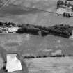 Oblique aerial view centred on the cropmarks of the fort, ring ditch and rig at Mains of Edzell with the farmstead adjacent, looking to the WSW.