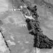 Oblique aerial view centred on the cropmarks of the fort, pits and rig at Mains of Edzell with the farmstead adjacent, looking to the SSE.